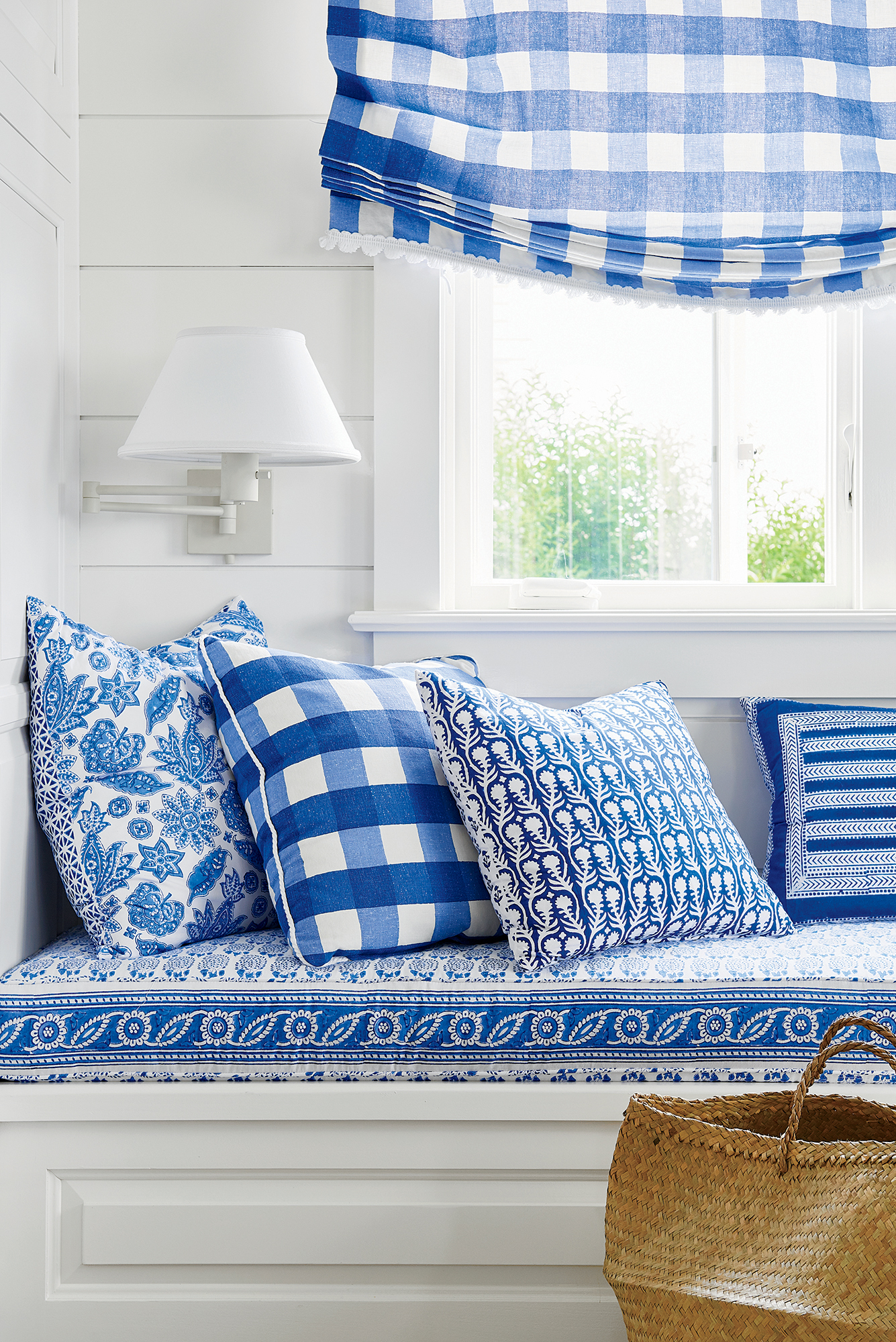 Blue and White Pillows on a Window Seat Designed by Mark D. Sikes