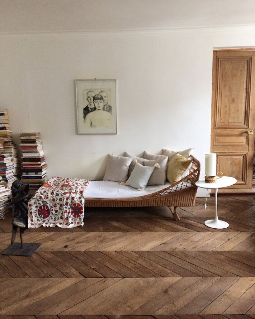 Vintage rattan French daybed by Atelier Vime with Suzani bedspread and Saarinen side table