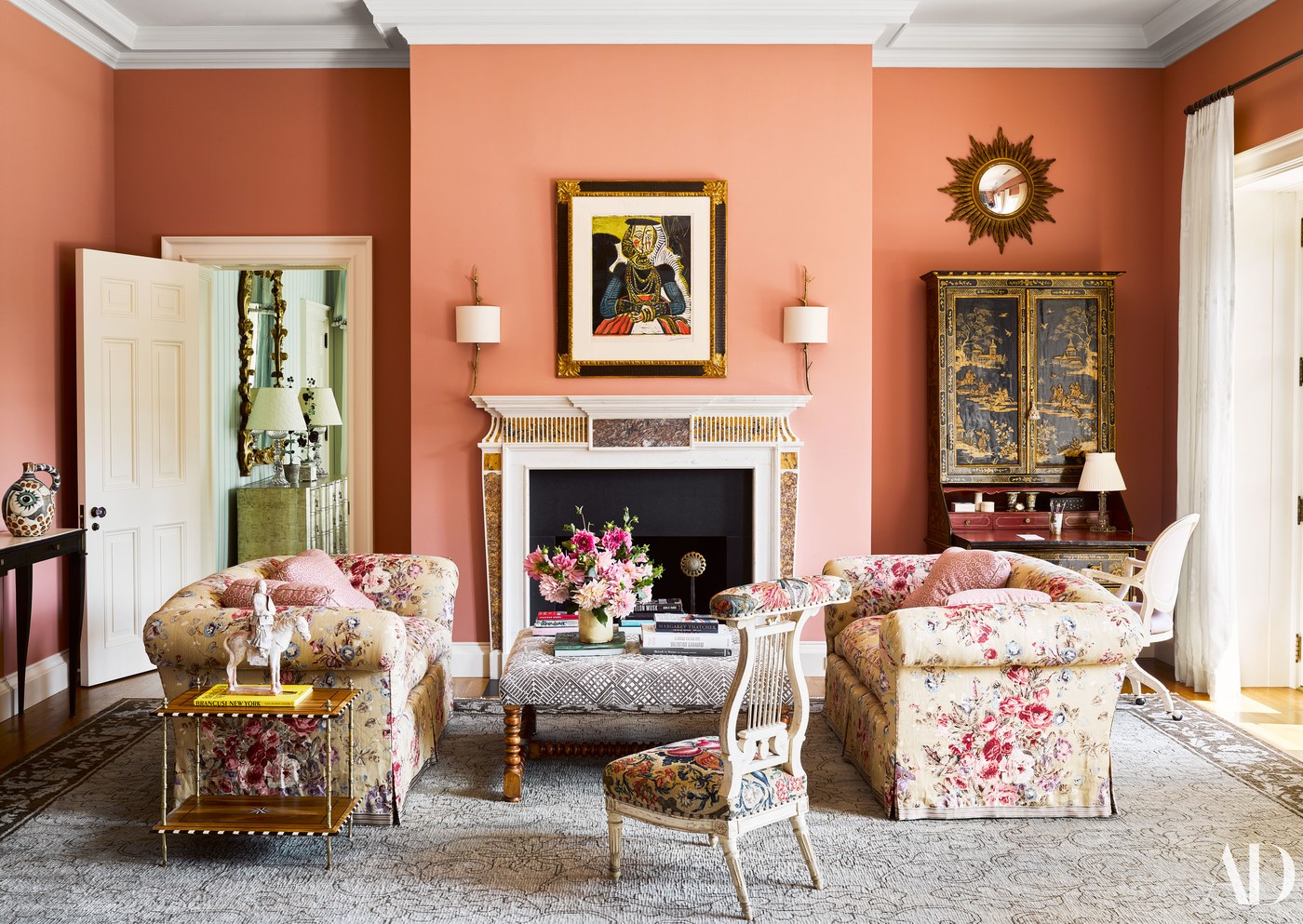 Pinks walls in a living room by Bunny Williams with floral chintz sofas