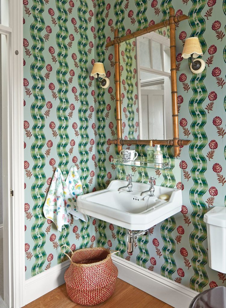 Rita Konig's English Farmhouse Bathroom with Pierre Frey wallpaper bamboo mirror matilda goad raffia scalloped lampshades