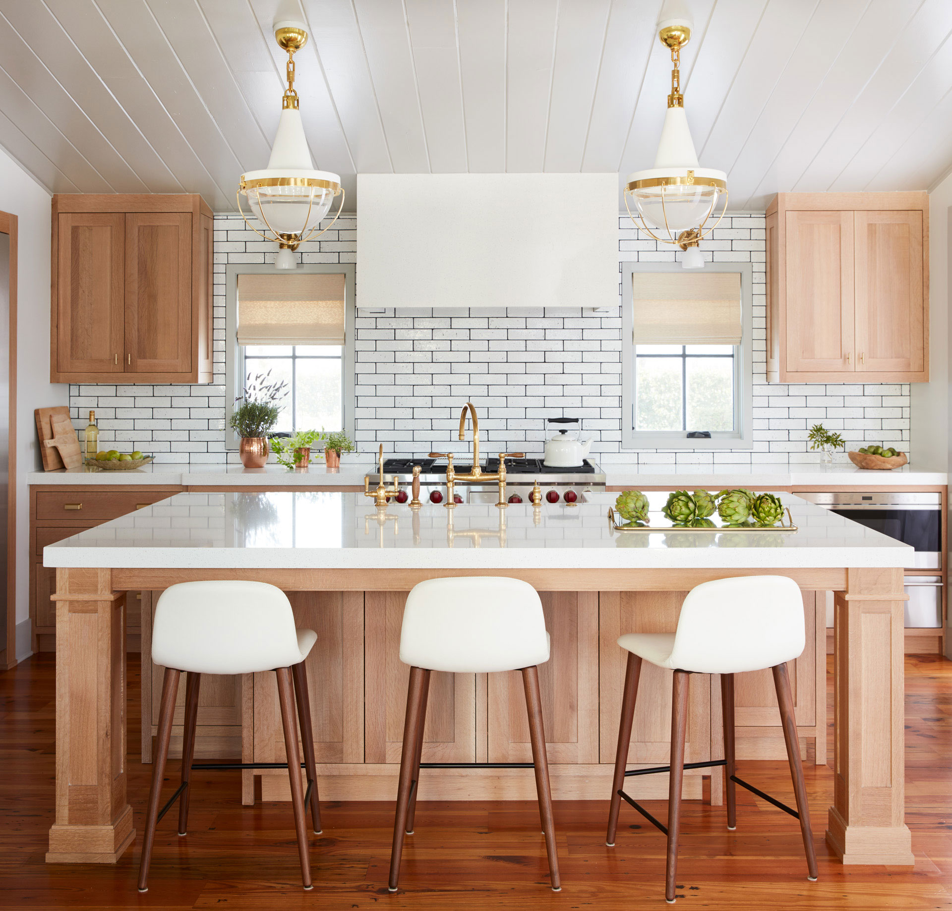 light wood cabinets with white countertops        <h3 class=